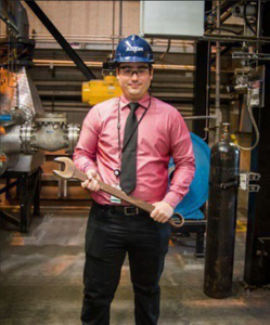 Jose J. Colon-Rodriguez wearing a hard hat and holding a wrench