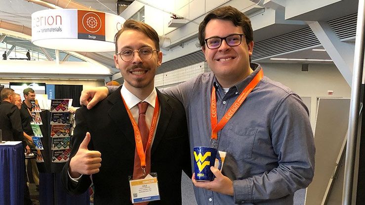 Matthew-Barre (Right) holding mug the team created for the Materials Science and Technology Contest with Cole-Klemstine (Left).