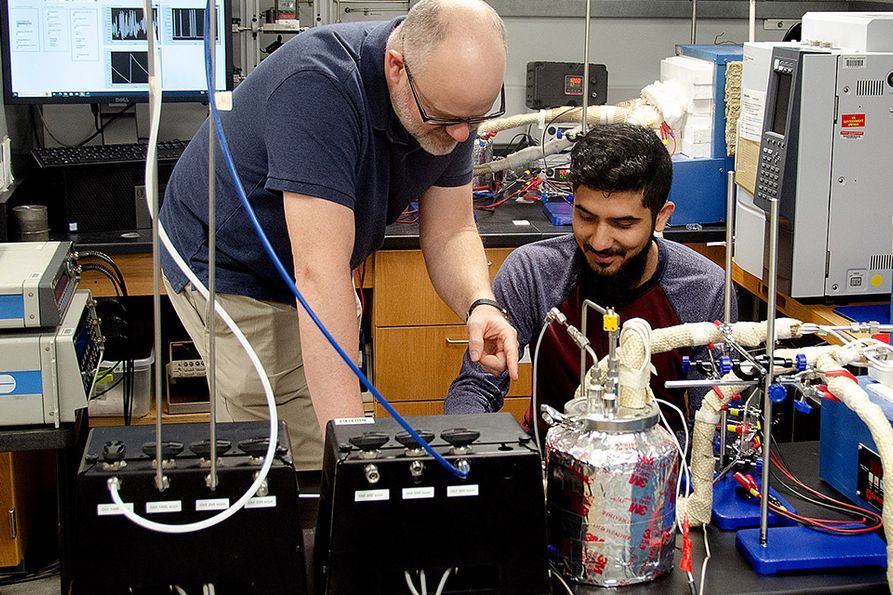 Mechanical, Materials, and Aerospace Engineering professor Ed Sabolsky (left) works with materials science PhD candidate Saad Waseem (right) on reducing emissions and increasing fuel efficiency in aviation.